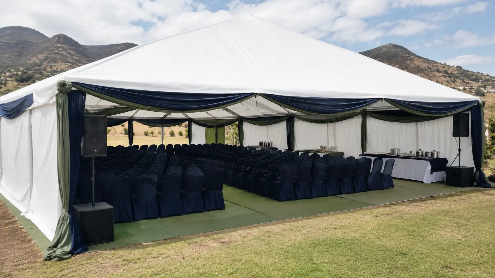 Funeral tent prepared with chairs and a PA system